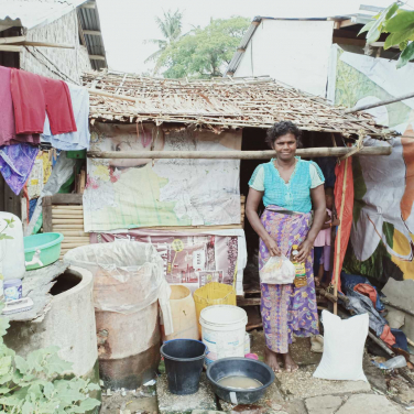 Residents in the Dagon Seikkan slum area use buckets to collect rainwater for drinking and daily uses